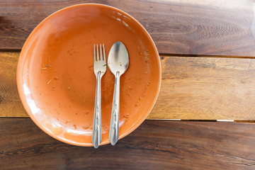Empty dish after food on wooden table