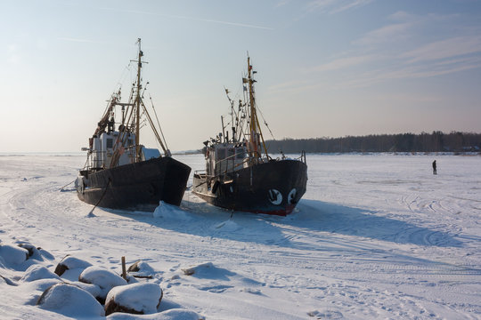 two old trawlers frozen in the ice