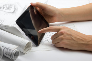 Architect working on blueprint. Architects workplace - architectural project, blueprints, ruler,...