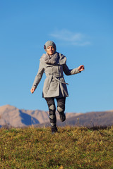 Fototapeta premium Girl in the meadow in the autumn campaign