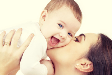 happy mother kissing baby