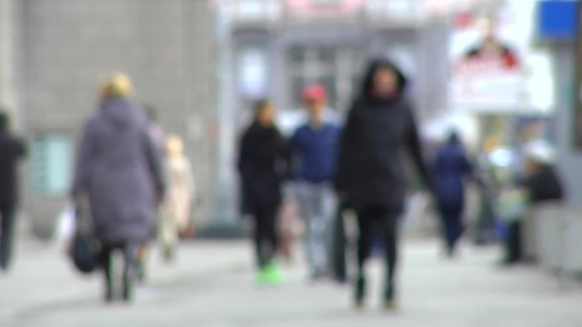 Pedestrian street with reaching people. Blur.