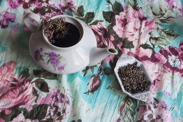 Teapot and Stand, black tea with flowers and branches of heather