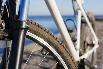 Close up on a bike parked in front of the seaside