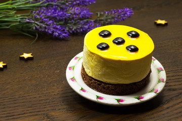 Cake on a saucer; flowers and stars on a dark background