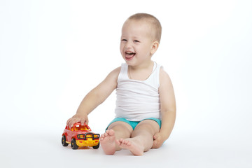 little boy plays with toy car