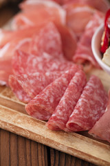 meat platter of Cured Meat and olives on old wooden board