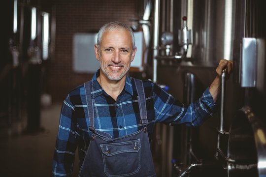 Happy brewer smiling at camera