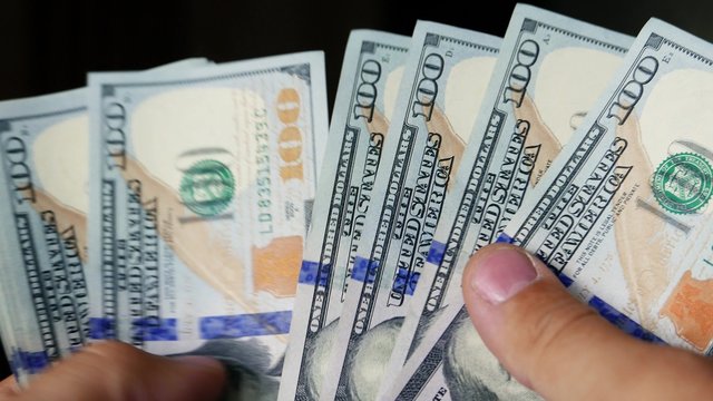 Person counting new money in hands. Lot of one hundred new US dollars banknotes. Cash, money, ready money, Finance & Business. Financial income, wages, sell, loan