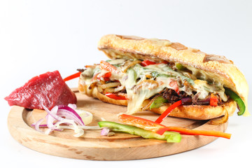 Tasty beef steak sandwich with onions, mushroom and melted provolone cheese in a ciabatta