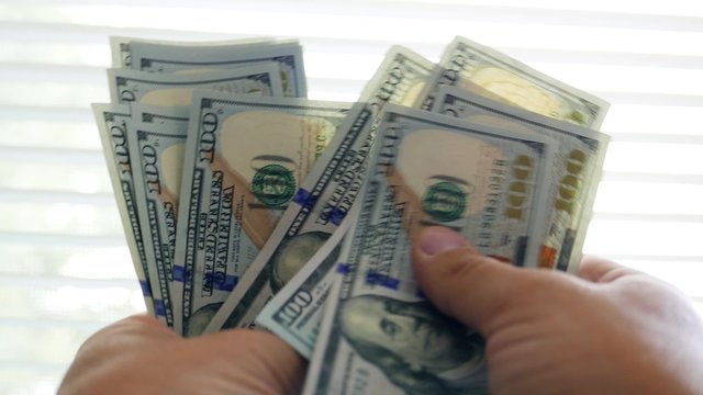 Person counting new money in hands. Lot of one hundred new US dollars banknotes. Cash, money, ready money, Finance & Business. Financial income, wages, sell, loan