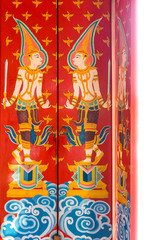 Vintage deity painting design on ancient wooden doors. The door entrance of Buddhist temple is at Wat Nong Waeng in Khon Kaen province, Thailand.