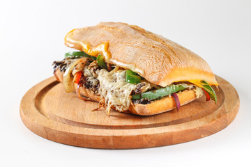 Tasty vegetarian sandwich in a ciabatta on a wodden plate