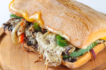 Tasty vegetarian sandwich in a ciabatta on a wodden plate