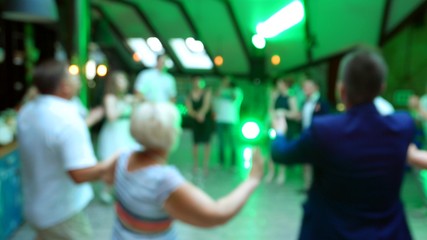 Many anonymous people dance disco on dance floor . Birthday, wedding party celebration fest, defocus