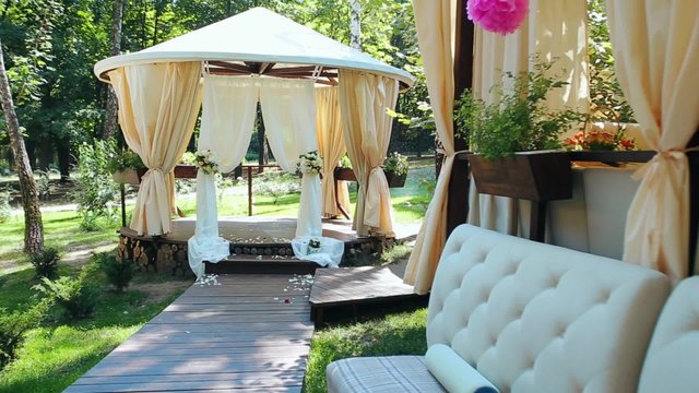 Decoration of the wedding secular  ceremony outdoor. Banquet in the summer hot sunny day