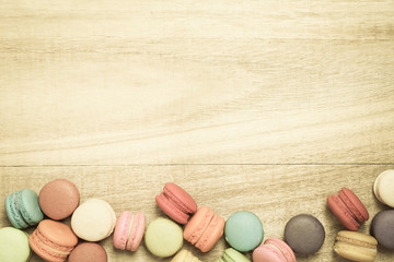 colorful macaroons on wooden background , top view
