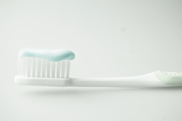 toothbrush with toothpaste in soft color
