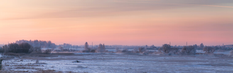 Cold winter dawn. Snowy morning panorama