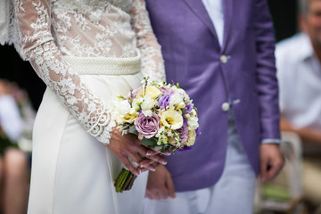 Happy couple, bride and groom at wedding aisle with bouquet clos