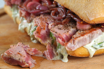 Tasty tuna steak sandwich in a ciabatta with lettuce, onions, Marie Rose sauce and lemon juice