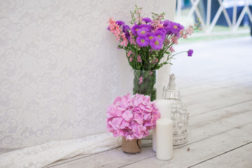 Stylish fresh pink an purple flowers at wedding reception closeu