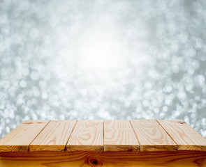 Wood table top with blur silver bokeh background