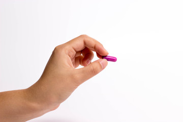 Fototapeta premium fingers holding a pill