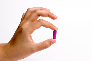 Fototapeta premium fingers holding a pill