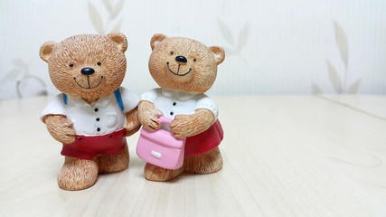 Couple of ceramic bear dolls go to school
