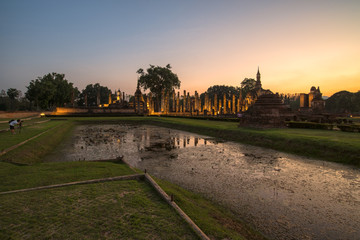 A photographer take a photo in the sunset time at ancient temple in Thailand