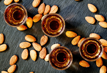 Amaretto almond liqueur with a dark background, top view