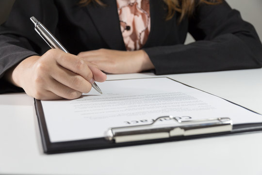 Business woman signing contract document form