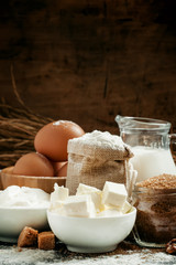 Baking ingredients: milk, butter, flour, sugar, eggs and rolling