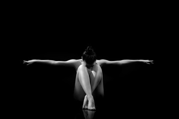 classic pose for erotic photo. nude girl  buried her knees and spread her arms to the side