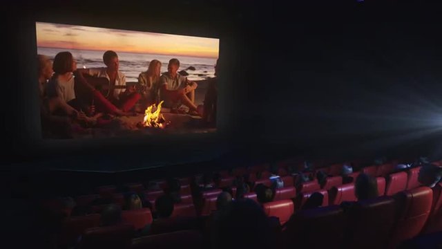 Group of people are watching a drama film screening in a movie cinema theater. Shot on RED Cinema Camera.