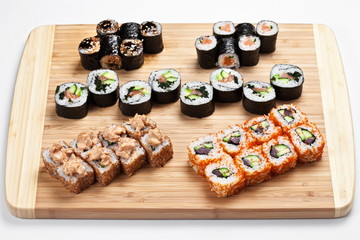 Sushi set with rolls and  nigiri  served on a wooden board 