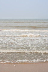 Frothy waves on beach - Incoming high frothy and foamy sea waves on a tropical beach in the evening.