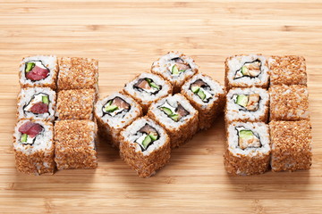 Sushi rolls  set  served on a wooden board background