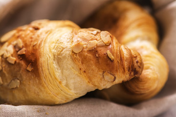 Fresh almond croissants and pitcher of milk. Tasty country breakfast concept. Rustic style. Selective focus