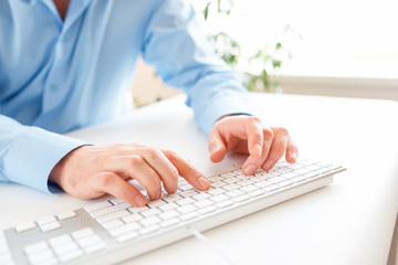Men office worker typing on the keyboard