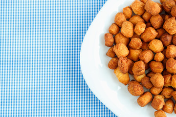 Cookies on a white plate and blue checkered tablecloths