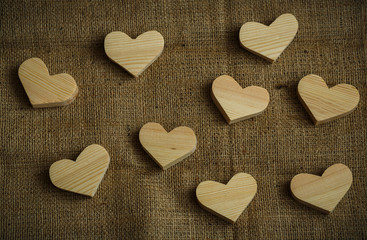 Fototapeta premium Wooden hearts on sackcloth background