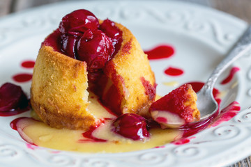 White chocolate fondant with cherry sauce.