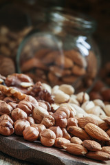 Nuts mix of pistachios, hazelnuts, walnuts and almonds on a wood