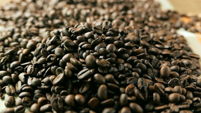 Roasted coffee beans poured in a heap