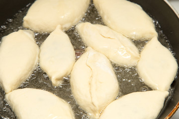 Food patties in a frying pan
