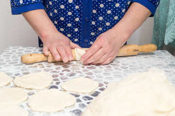 sheeting the dough with a rolling pin in the kitchen