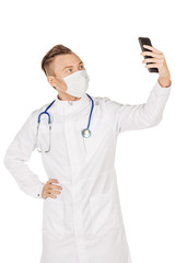 Medical doctor in white coat with stethoscope and mask taking a