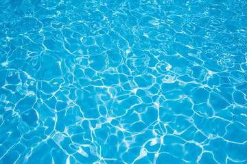 Fototapeta na wymiar Water in swimming pool with sun reflection